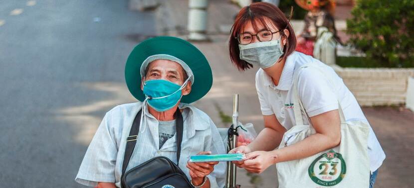 Woman from Trung Son Pharma helping man in Vietnam