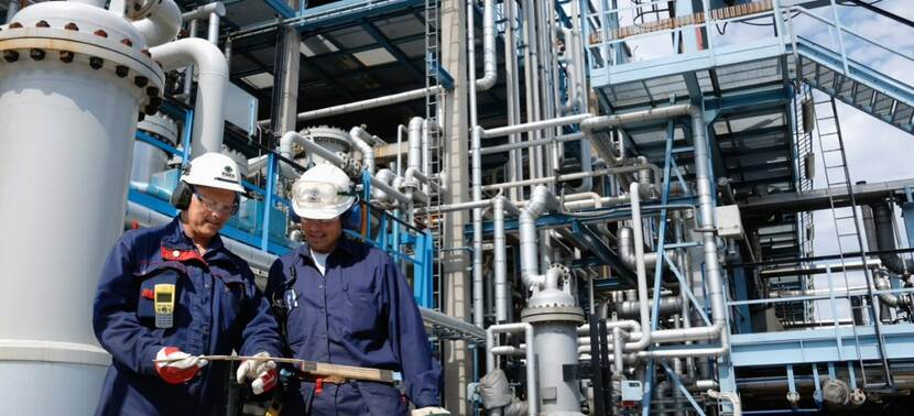 Two men working with VISICS safety monitoring system in industrial space.